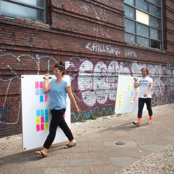 Zwei Hipster laufen mit Whtieboards und post-its durch Berlin Wedding